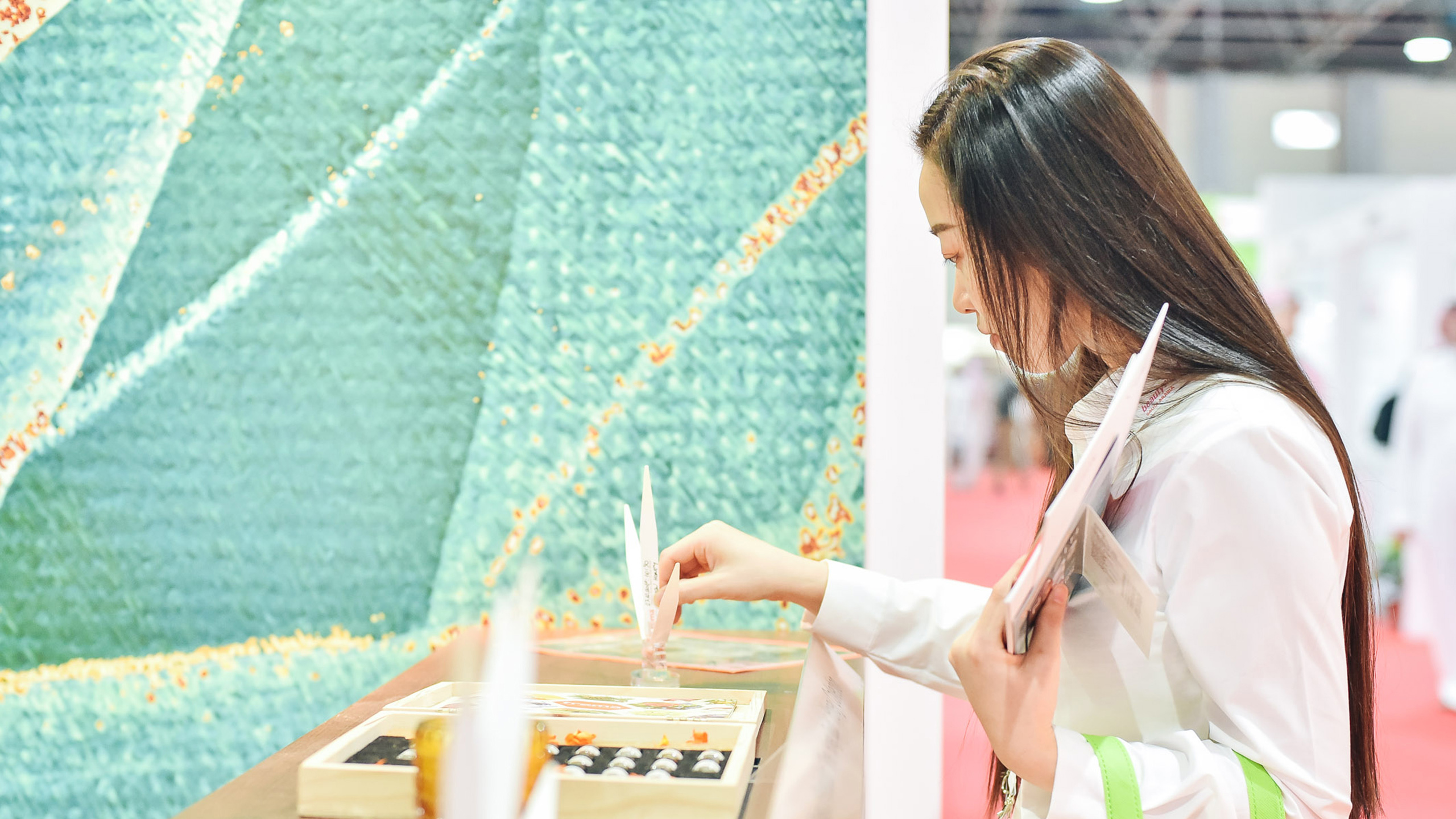 Beautyworld Saudi Arabia - Visitor checking out products at the tradeshow